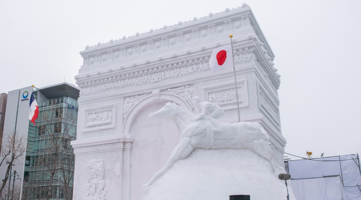 A close-up photograph capturing the triumphal arch sculpture featured at the Sapporo Snow Festival.