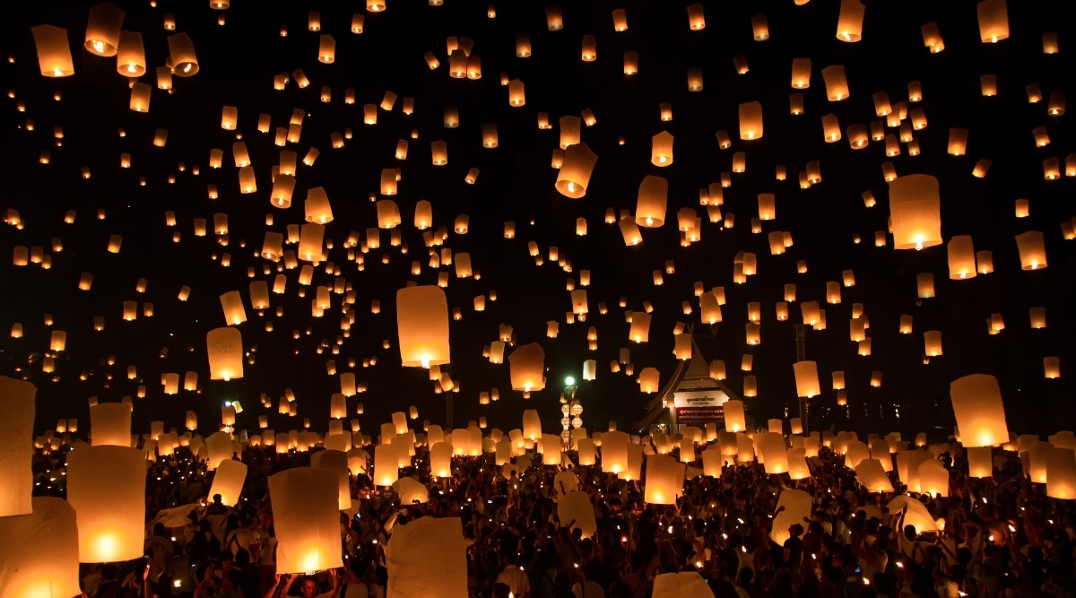 A photograph capturing numerous sky lanterns at the Sky Lantern Festival. The image showcases a multitude of lanterns released into the night sky, creating a visually striking display.