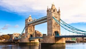 A photograph capturing the London cityscape featuring the iconic Tower Bridge, viewed from the South Bank of the River Thames in the morning light.