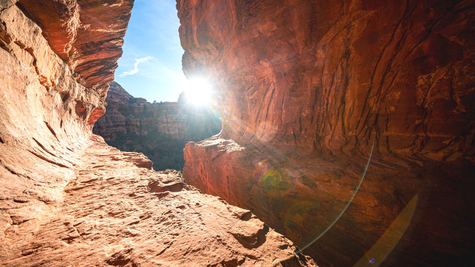 A photograph depicting Boynton Canyon in Sedona, Arizona. The image showcases the canyon's rugged terrain and red rock formations, typical of the region's natural landscapes.