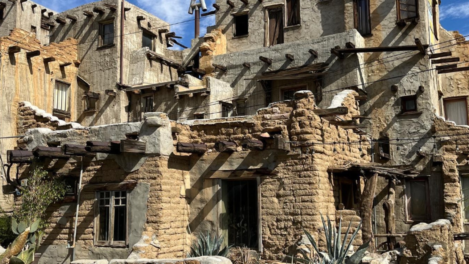 Cabot's Pueblo Museum is a remarkable architectural gem nestled in the desert landscape of Desert Hot Springs, California. Its exterior is characterized by rugged adobe walls, intricate wooden detailing, and a towering four-story turret.