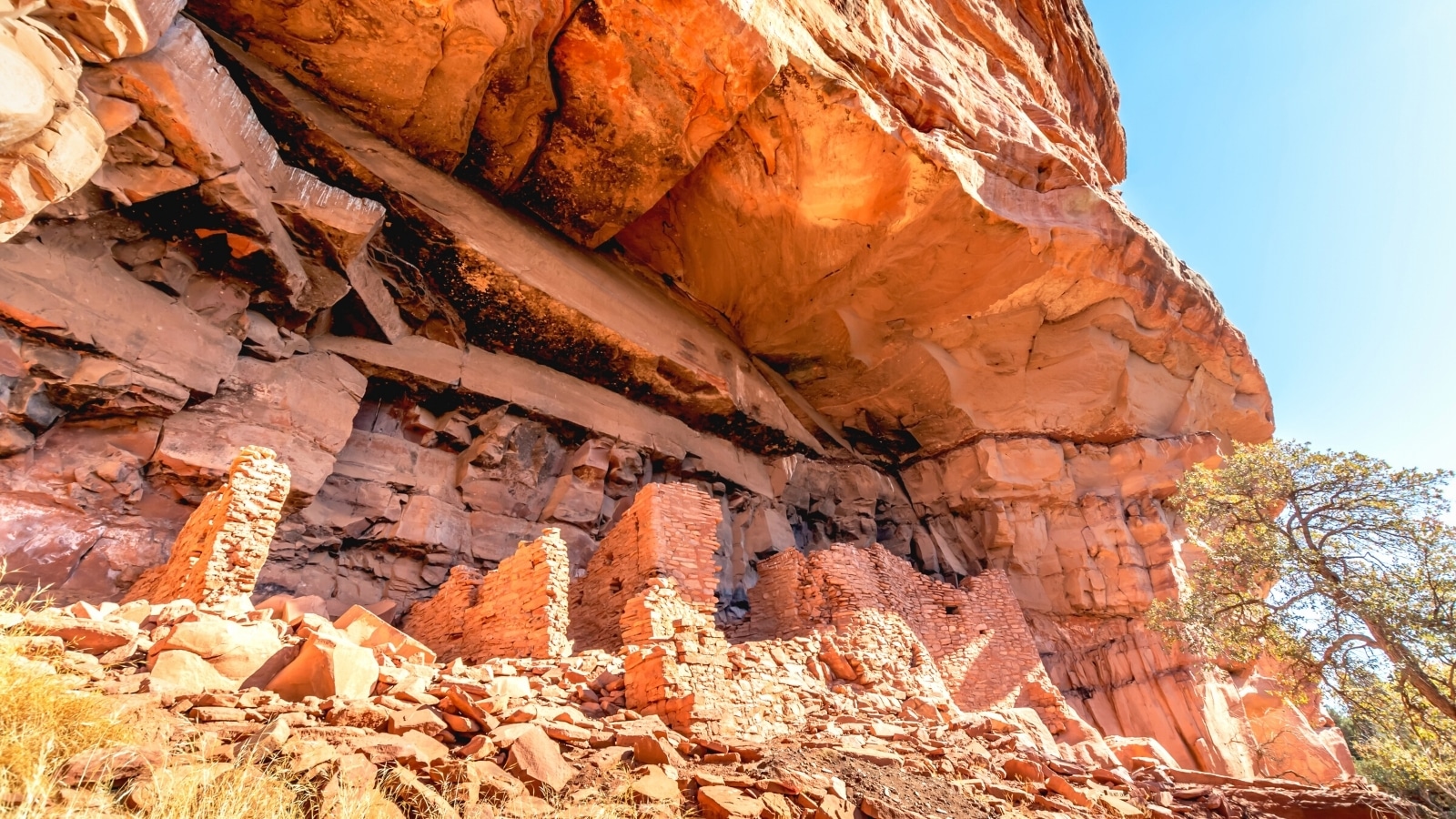 A photograph depicting Honanki Heritage Site in Sedona, Arizona. The image showcases ancient rock formations and cliff dwellings, characteristic of the Native American heritage in the region.