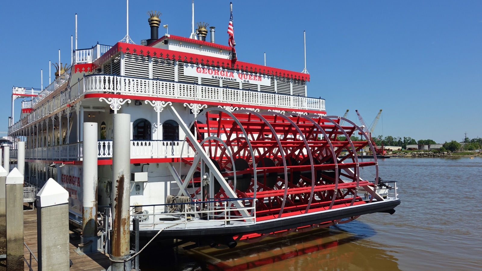 The image showcases the vessel's color scheme, featuring predominantly white surfaces with distinct red elements. The ship's design appears straightforward, with the red accents adding a touch of color to an otherwise neutral palette.