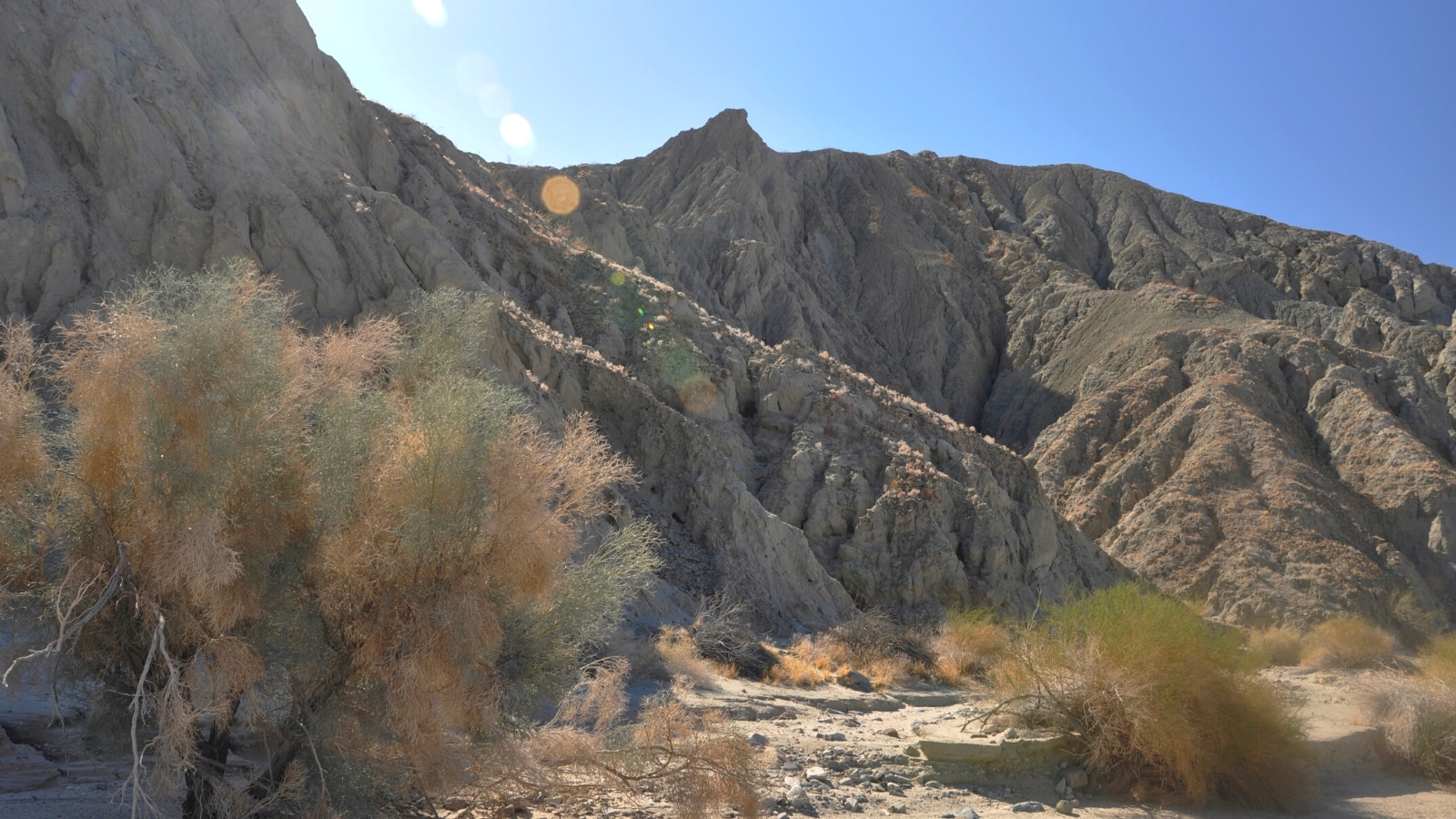 A photograph depicting the Painted Canyon Trail, showcasing a landscape characterized by mountains and rocks.
