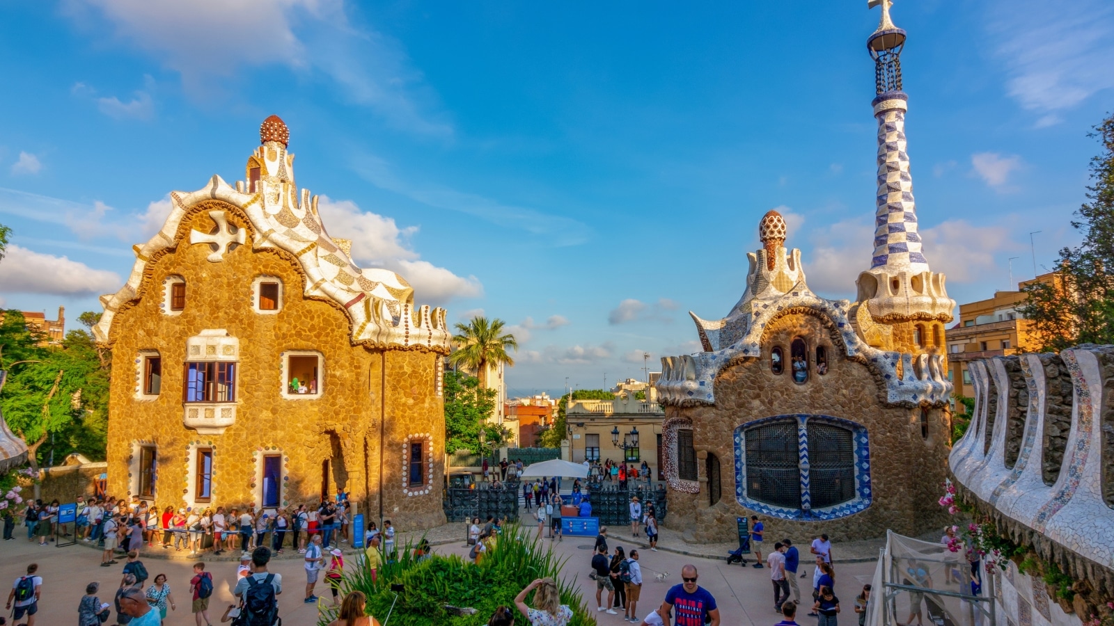 A photograph capturing Park Güell in Barcelona, designed by architect Antoni Gaudí. The image features the architectural elements and landscapes characteristic of the park.