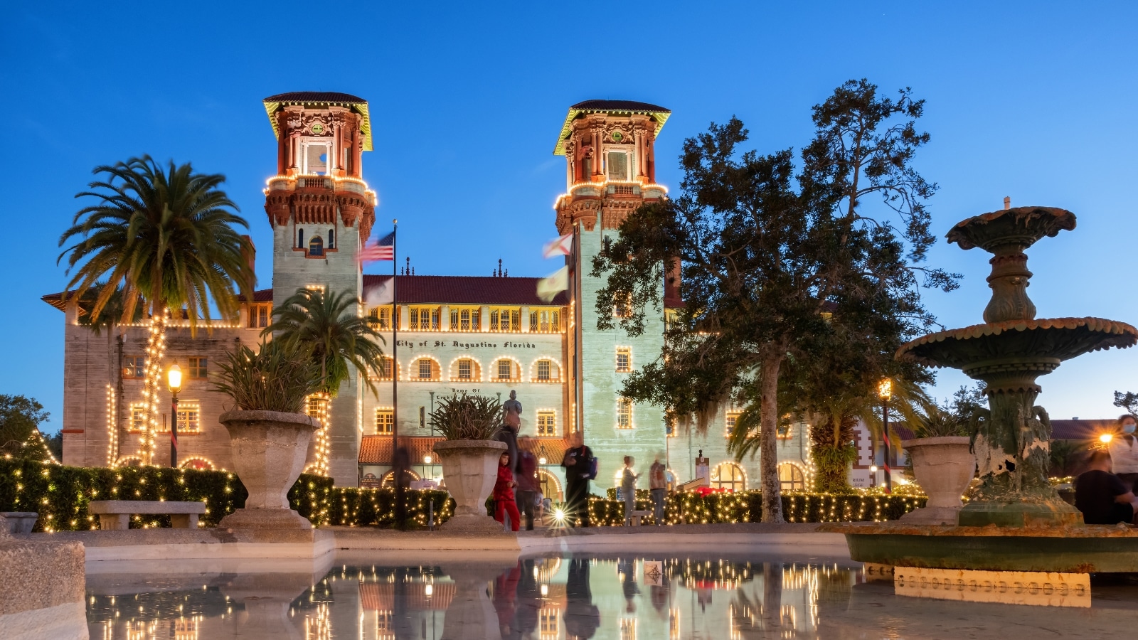 The image captures the evening twilight scene at Lightner Museum in St. Augustine, Florida. The soft glow of twilight enhances the historical charm of the museum's architecture, highlighting its intricate details and grandeur.