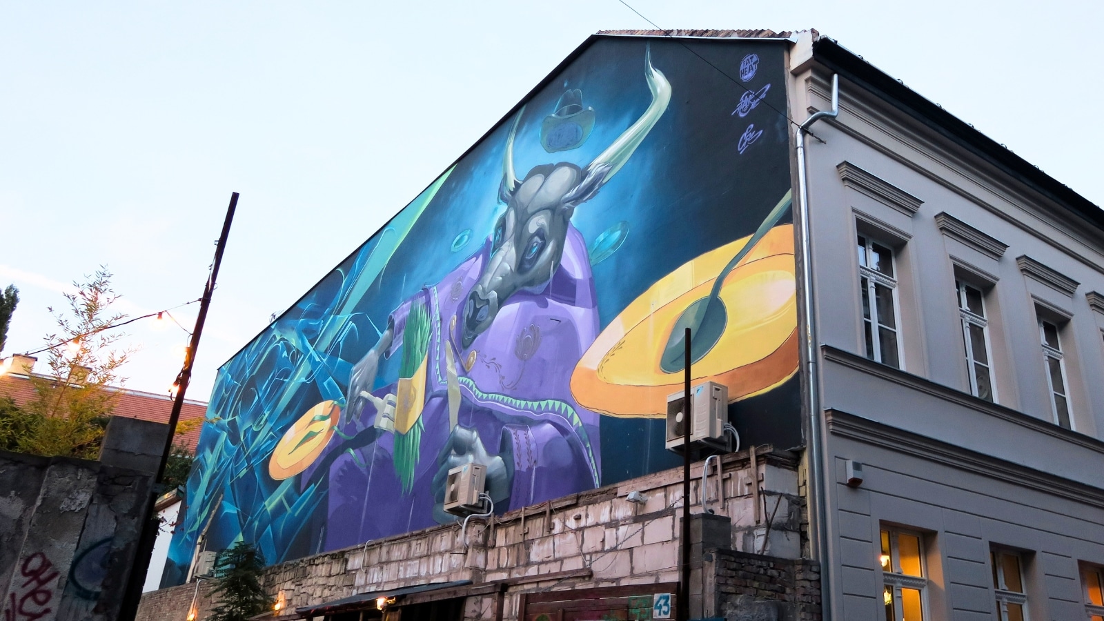 The image features graffiti in Budapest's Jewish Quarter, Hungary. The artwork reflects the vibrant and artistic culture of the area.