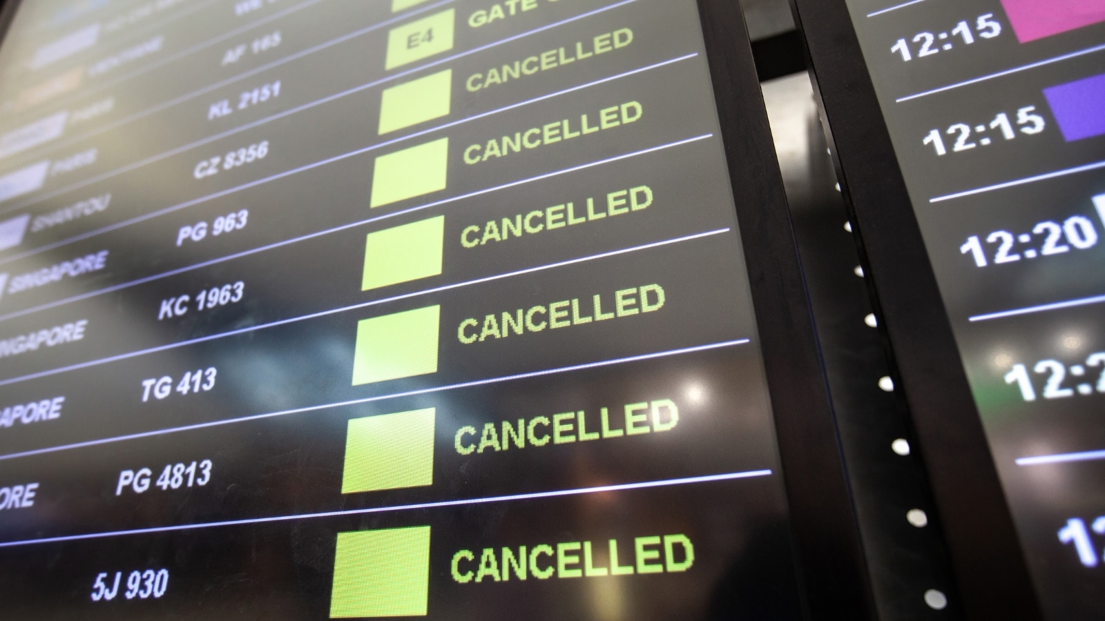 The image depicts a close-up view of a flight board at an airport displaying "Canceled" in all lines, indicating the cancellation of flights.