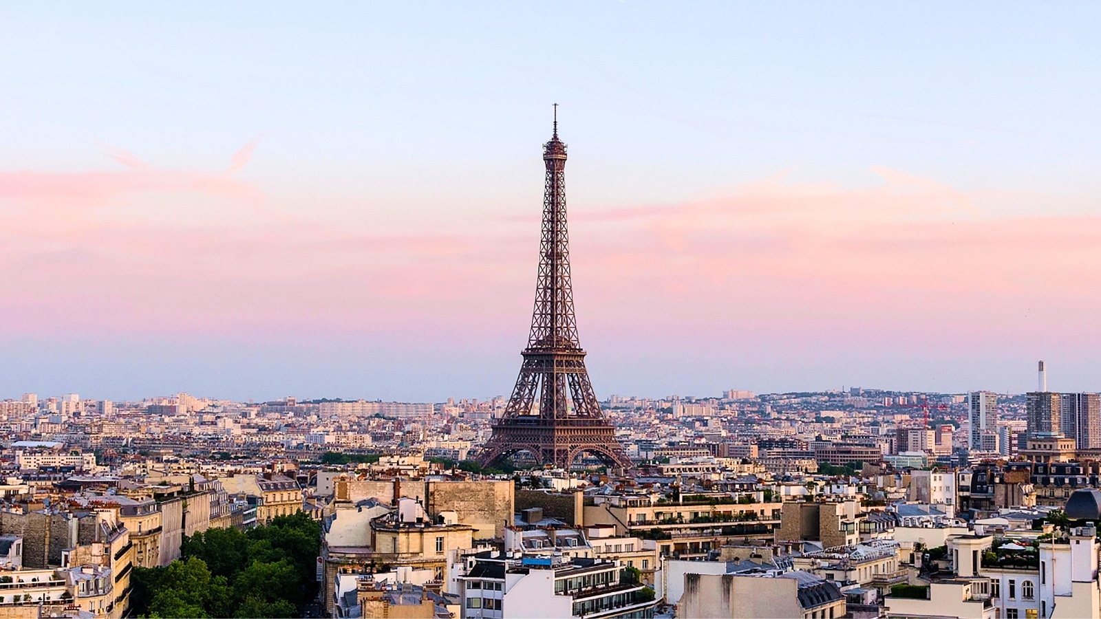 The image features a beautiful view of the Eiffel Tower in Paris, the capital of France. The background is depicted in natural colors, adding to the aesthetic appeal of the scene. The Eiffel Tower stands tall and iconic against the backdrop, symbolizing Parisian architecture and heritage.