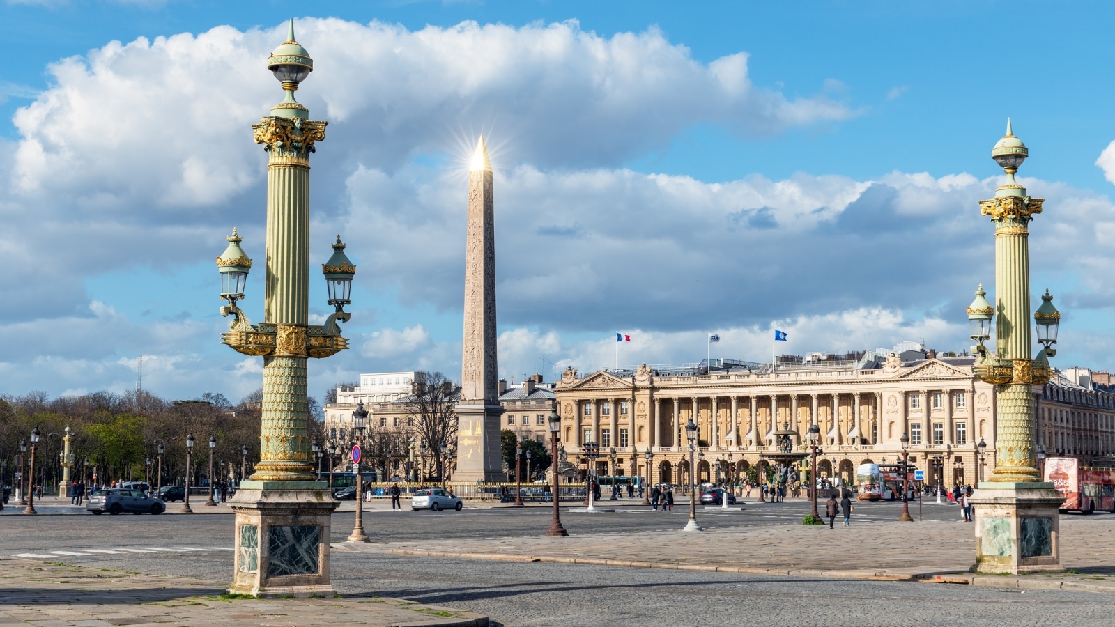 The image captures the Luxor Obelisk at Place de la Concorde in Paris, France. The obelisk is a tall, slender monument with a pointed top, standing prominently in the center of the square.