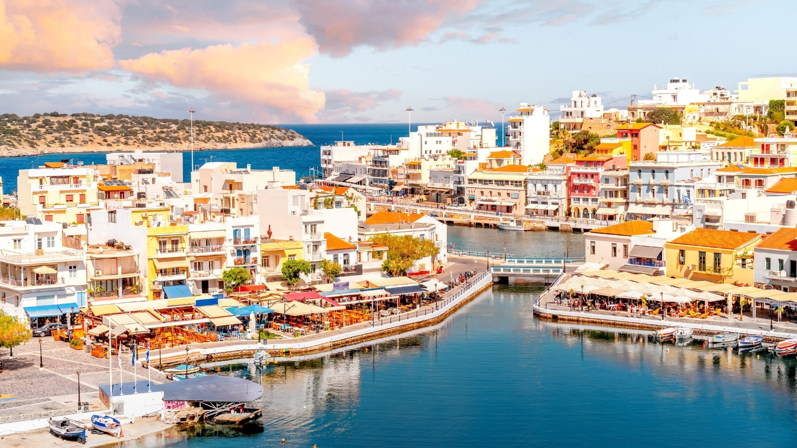 Agios Nikolaos on the island of Crete, Greece. The architecture of the buildings in this area is traditional and charming. The houses around the creek exhibit a variety of bright and colorful facades.