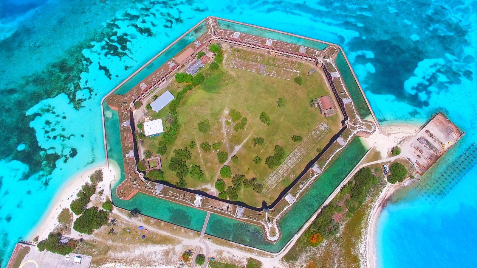The fort stands prominently amidst the ocean, highlighting its strategic coastal location. The composition emphasizes the architectural details of the coal structure, showcasing its historical significance within the park. Surrounding the fort is the vast expanse of the ocean.